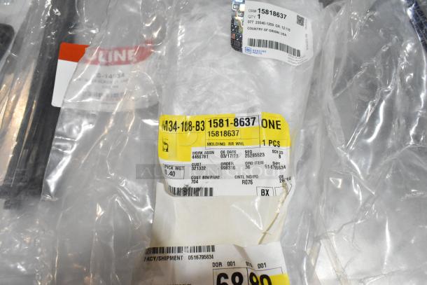 Lot of various items including floor mats and cable ties in a black poly bin. Tags show item numbers 15818637 and related details.