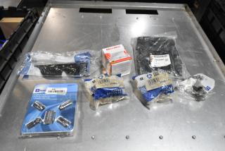 Lot of various items including GM wheel locks, 23305978 stabilizer shaft insulator, and more in black poly bin.