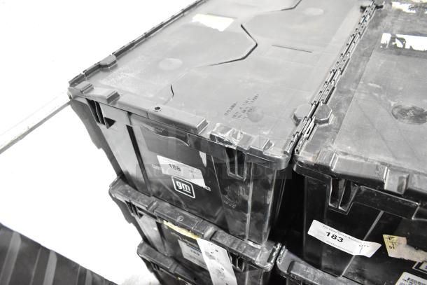 Black poly bin containing various items including wheel locks and 23305978 stabilizer shaft insulator. GM branding visible.
