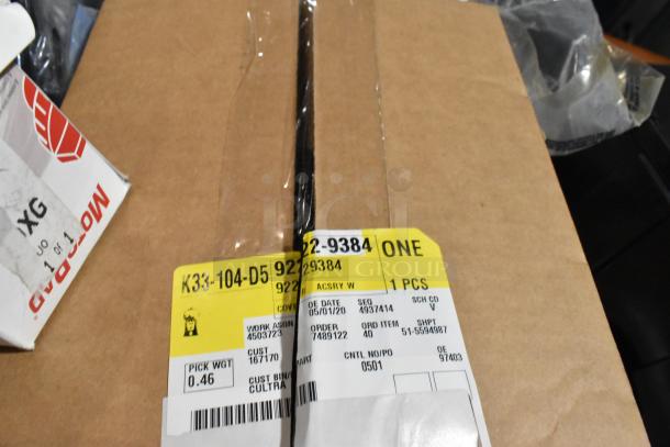 Lot of items in black poly bin, including wheel locks and 23305978 stabilizer shaft insulator. Box with labels visible.
