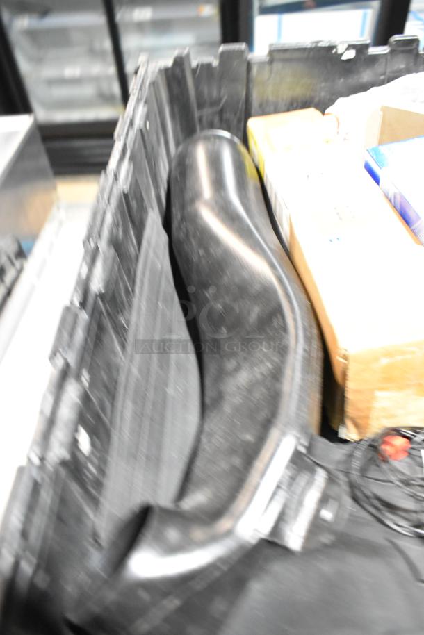 Black poly bin containing various items, including an oil filter and GM 84126999 emblem. Items appear used.