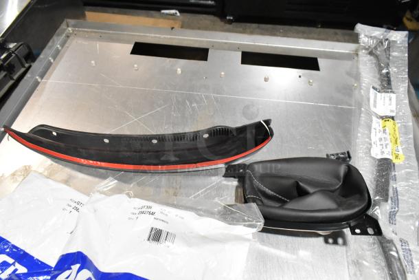 Lot of various items including GM 84713664 door handles, in a black poly bin. Items are new with packaging.
