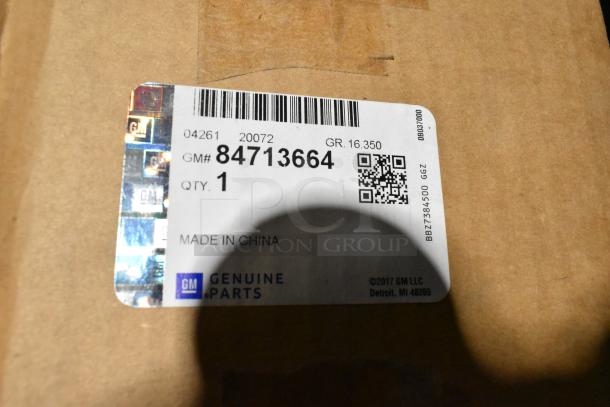 Lot with GM 84713664 door handles, label showing GM Genuine Parts, qty 1, in a black poly bin. Made in China.