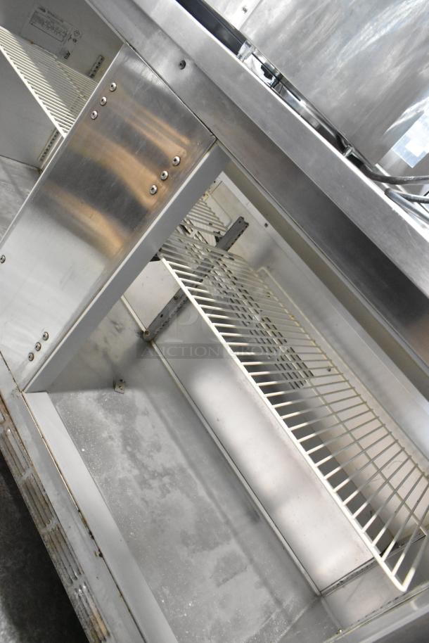 Beverage Air WTR60A stainless steel 2-door undercounter cooler on casters, with shelving, showing interior condition.