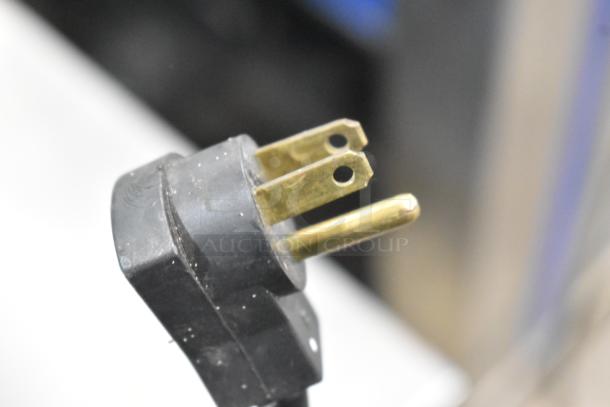 Close-up of a standard three-prong electrical plug for a Beverage Air UCR48A cooler, 115V, 1 phase.