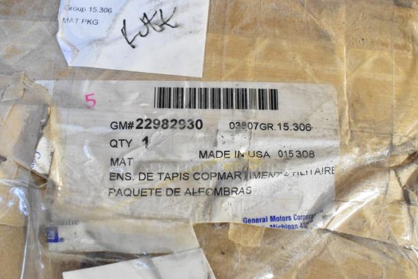 Two sealed boxes with Buick floor mat, GM# 22982930. Made in USA. Packaging shows minor wear. Includes barcode and labels.