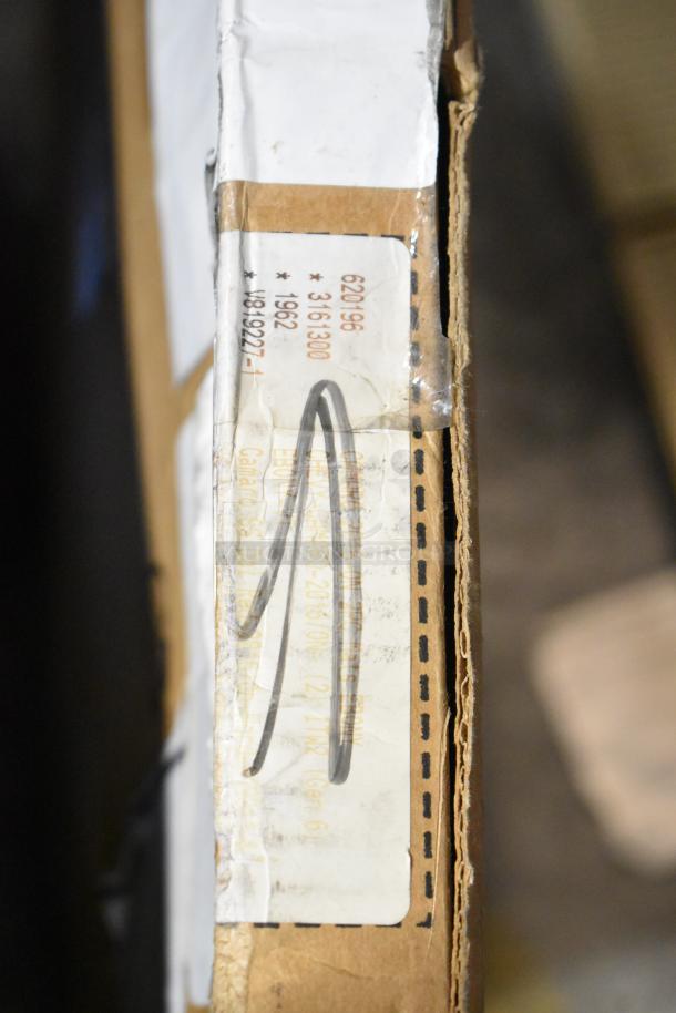 Cardboard box with label displaying codes and descriptions for GM and Corvette floor mats, marked "scratch and dent."