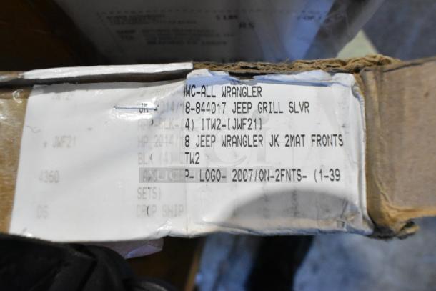 Label on shipping box detailing auto parts including Jeep grill and Wrangler floor mats. New scratch and dent items.
