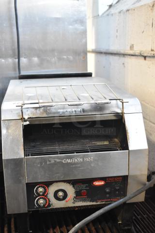 Hatco TQ-800HBA stainless steel commercial conveyor toaster, used condition, 208 volts, 1 phase, warning labels visible.