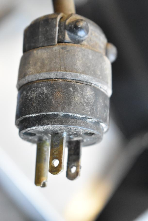 Close-up of the electrical plug for a Holman Stainless Steel Conveyor Toaster Oven, showing wear. 208V, 1 Phase.