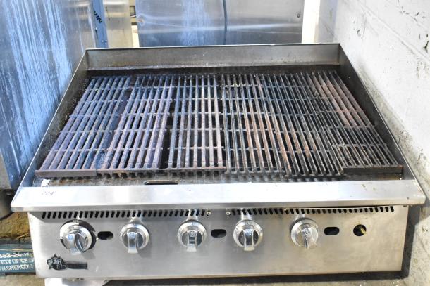 Star stainless steel commercial countertop charbroiler grill with four control knobs, showing moderate use and wear.