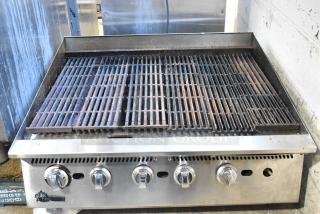 Star stainless steel commercial countertop charbroiler grill with four control knobs, showing moderate use and wear.