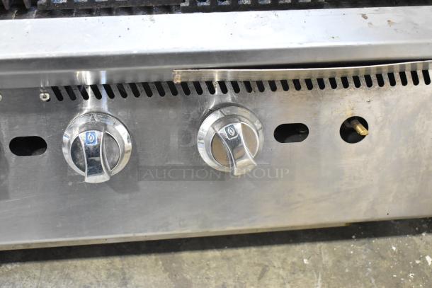 Star stainless steel commercial countertop charbroiler grill, features three control knobs, signs of use, durable design.