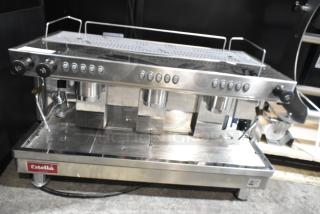Brand new Estella ECEM3/N3 stainless steel 3-group commercial espresso machine. Shows buttons; 220-240V, 1 Phase.