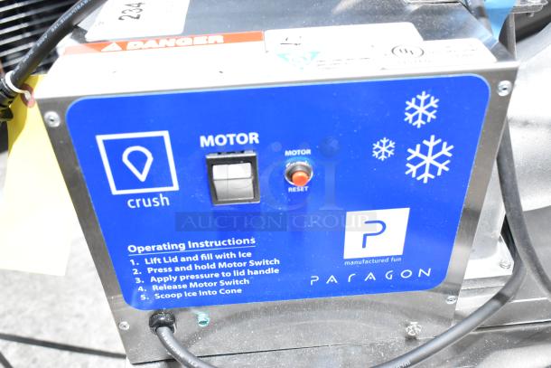 Paragon Simply-A-Blast Snow Cone Machine, model 6133300. Brand new with minor scratches. 120V, 1-phase. Operating instructions visible.