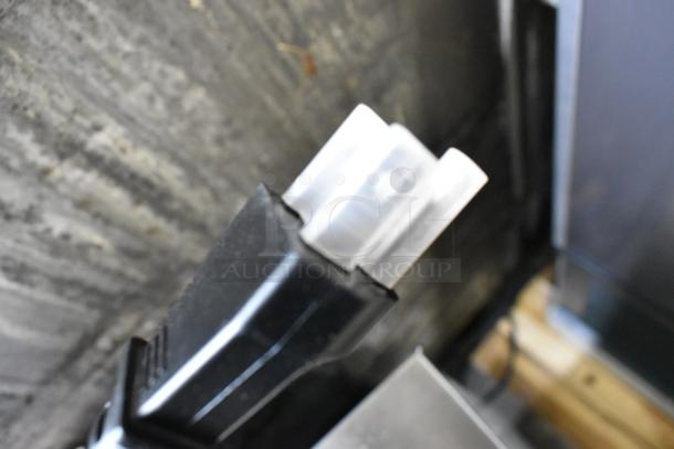 Close-up of a black plastic power plug for a 2024 Waring WWD180X Single Classic Waffle Maker, 120 Volts, 1 Phase.