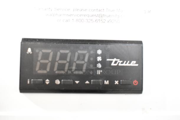 2021 True TSCI-600R-G-PH commercial cooler display panel showing digital temperature and control buttons.