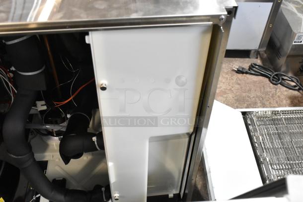 Brand new Scotsman MC0830MR-32A 30" stainless steel ice machine. Visible interior components. Scratch and dent condition.