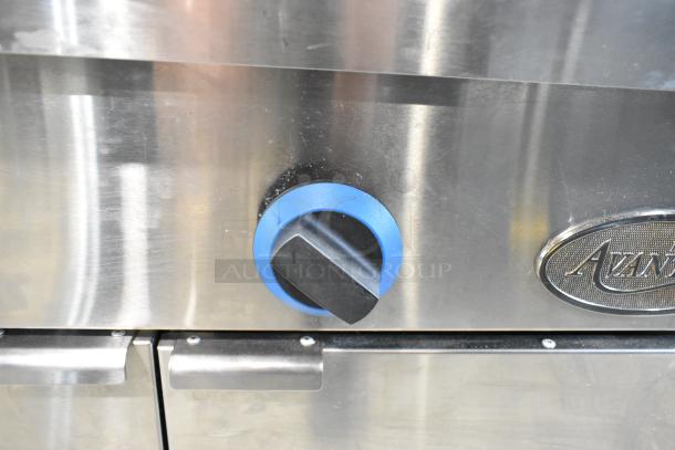 Stainless steel control panel of Avantco 177FPC22NL pasta cooker with blue handle and brand logo, showing minor scratches.