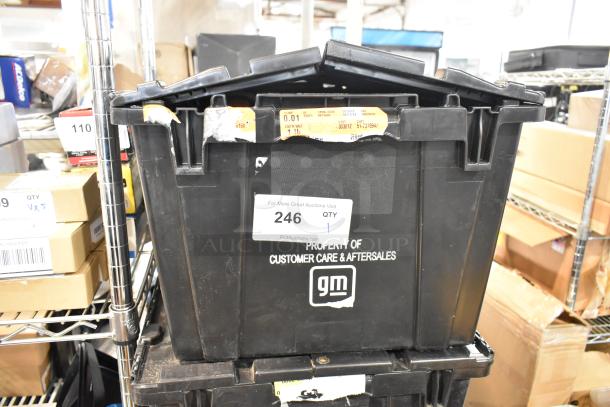 Black poly bin labeled "Property of Customer Care & Aftersales" containing assorted items including scissors. Auction tag "246".