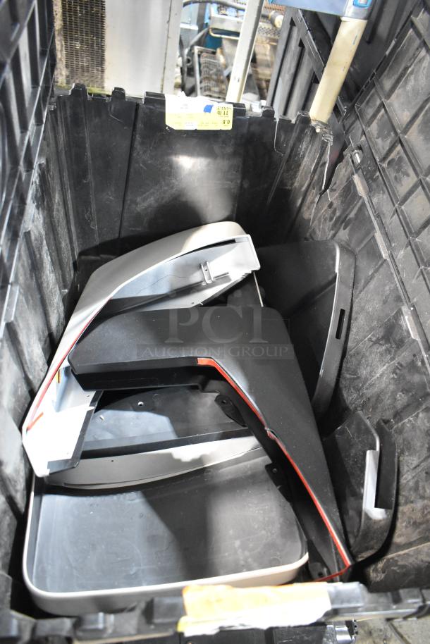 Black poly bin containing various GMC panels, multiple pieces visible, label attached to bin edge.