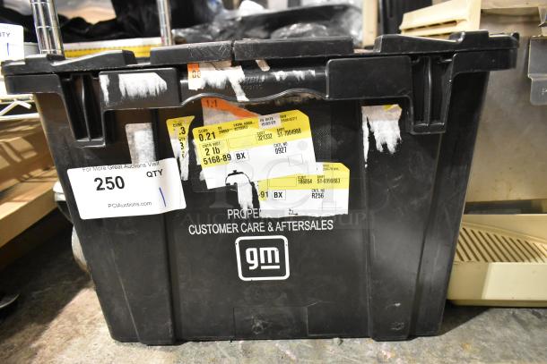 Black poly bin with Corvette emblem and various items. Labels show shipping and customer care details. Good condition.