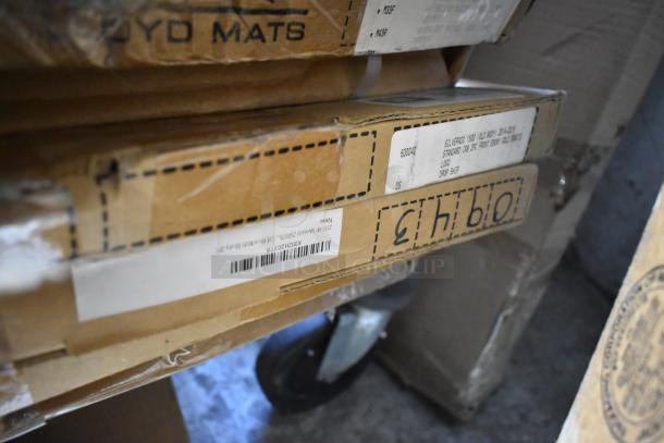 Cardboard boxes labeled with shipping info, containing car mats, part of 18 various auction items.