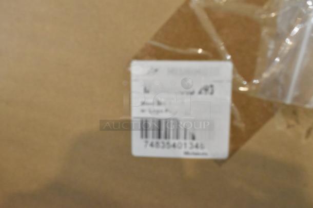 Package label showing product code and partial description. Blurred barcode and handwritten "493".