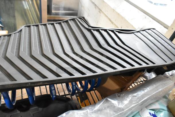 Auction lot with black rubber car mats and blue coils, various items, good condition.