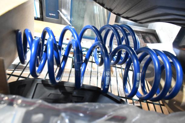 Blue car coil springs and black car mats, new in condition, part of a mixed auction tier lot.