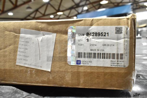 Box with GM 84289521 mud guard label, marked "Made in USA." Includes ACDelco air filter. Package shows shipping details.