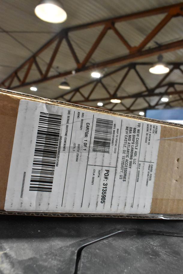 Cardboard package with shipping label indicating GM 84289521 mud guard inside. Barcode and shipping details visible.