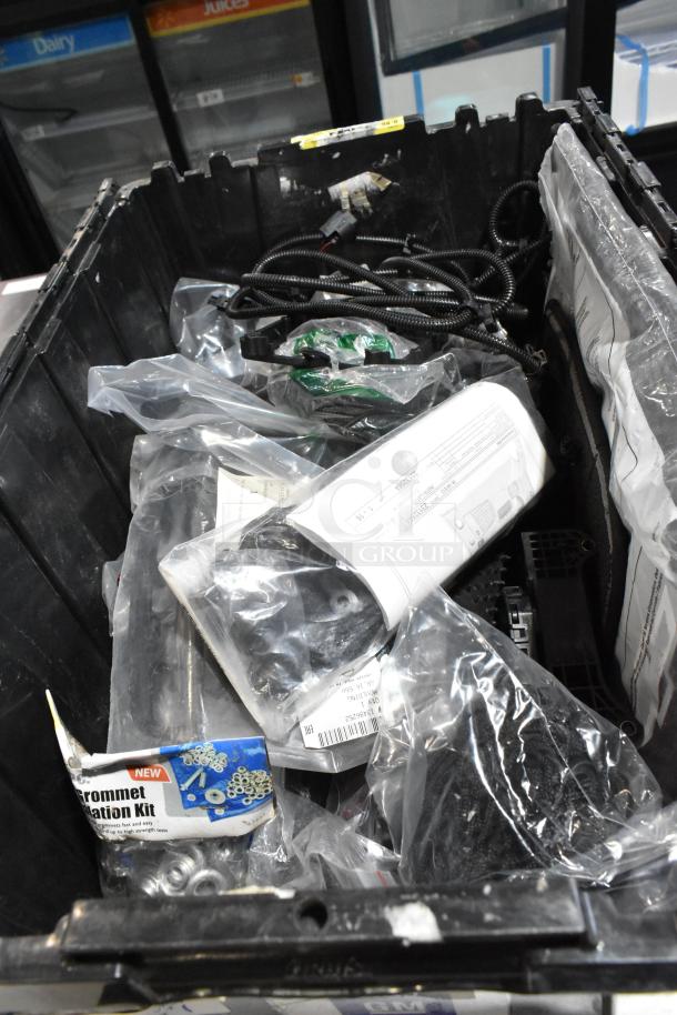 Lot of various items in black poly bin, including GM 20823543 front driver side fender ornament and grommet installation kit.