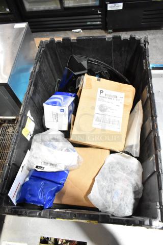 Lot of various items including GM front driver side fender ornament model 20823543 in a black poly bin; labeled packages visible.