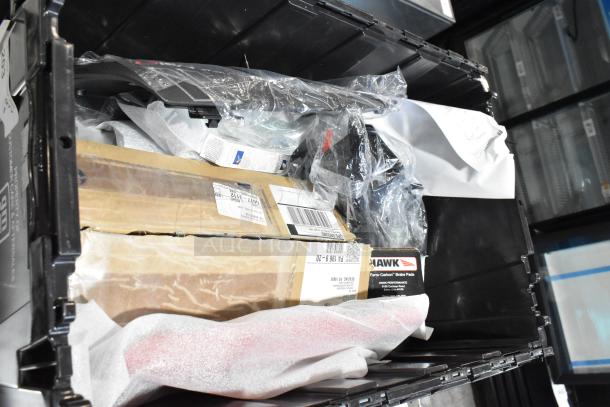 Lot of various items including Hawk Racing disc brake pads in a black poly bin. Varied packaging and conditions visible.