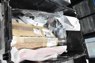 Lot of various items including Hawk Racing disc brake pads in a black poly bin. Varied packaging and conditions visible.