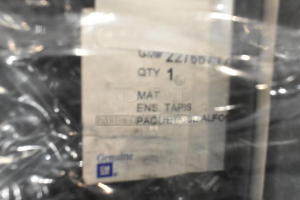Lot of various items in a black poly bin, including a mat. Visible label shows "Genuine GM" and quantity 1.