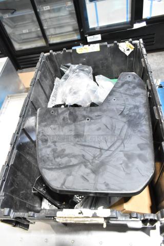 Lot of various items including ACDelco power steering fluid in used black poly bin with visible wear and label markings.