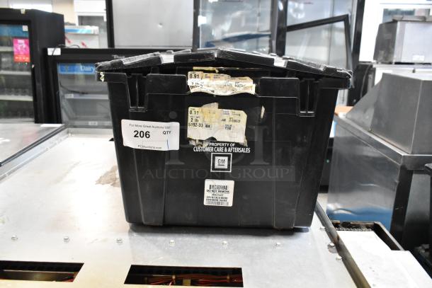 Black poly bin labeled "Property of Customer Care & Aftersales" with sticker "206". Includes ACDelco power steering fluid.
