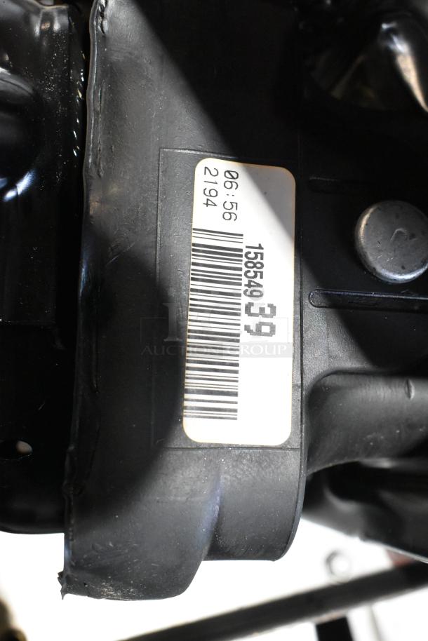 Black poly bin with various items, including ACDelco Power Steering Fluid. Visible barcode label with numbers.
