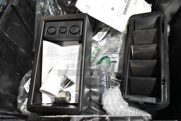 Lot of items in black poly bin, includes GM 23221725 Universal Tablet Holder. Various tools, labels, and documents visible.