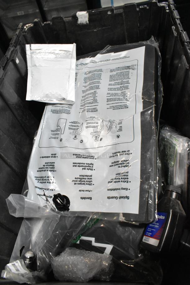 Lot of various items in a black poly bin, including a GM 23221725 Universal Tablet Holder. Items appear in mixed condition.