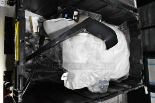 Lot of various items in a black poly bin, includes miscellaneous plastic components and wrapped parts; good condition.