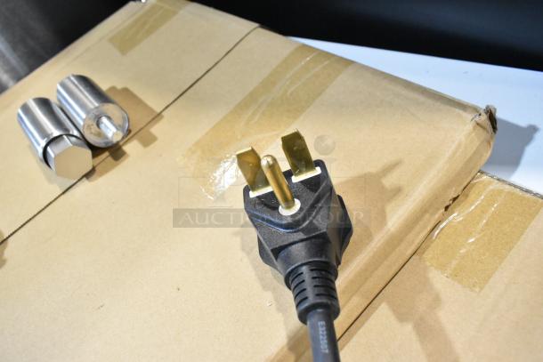Avantco 177CO46M convection oven power cord and accessories on cardboard packaging. Oven is new with minor dents.