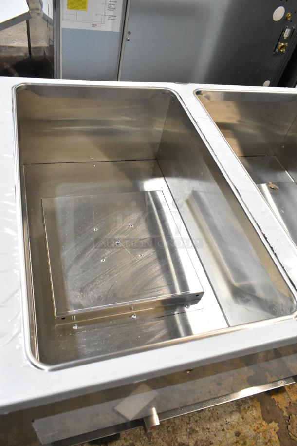 Brand new ServIt 423GST3WENG stainless steel three-pan steam table, open well, natural gas, 10,500 BTU, slight dents.