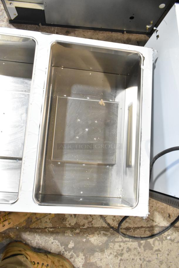 Brand new scratched ServIt 423GST3WENG stainless steel three-pan steam table, 10,500 BTU, open well, natural gas.