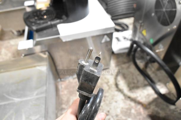 Close-up of plug for Avantco 177EG30N electric griddle. Black cable with two-prong plug, stainless steel background.
