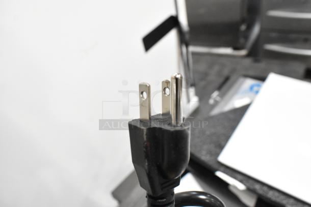 Close-up of a three-prong plug from a 2025 Avantco 177CMADAP Digital Automatic Airpot Coffee Maker, 120V, 1 Phase.