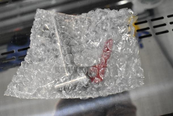 Bubble-wrapped item, potentially one of five brand new scratch and dent components, including Avantco and Amana parts.