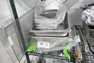 Brand new stainless steel steam table pans and Avantco back grille. Includes labels showing item quantity and codes.